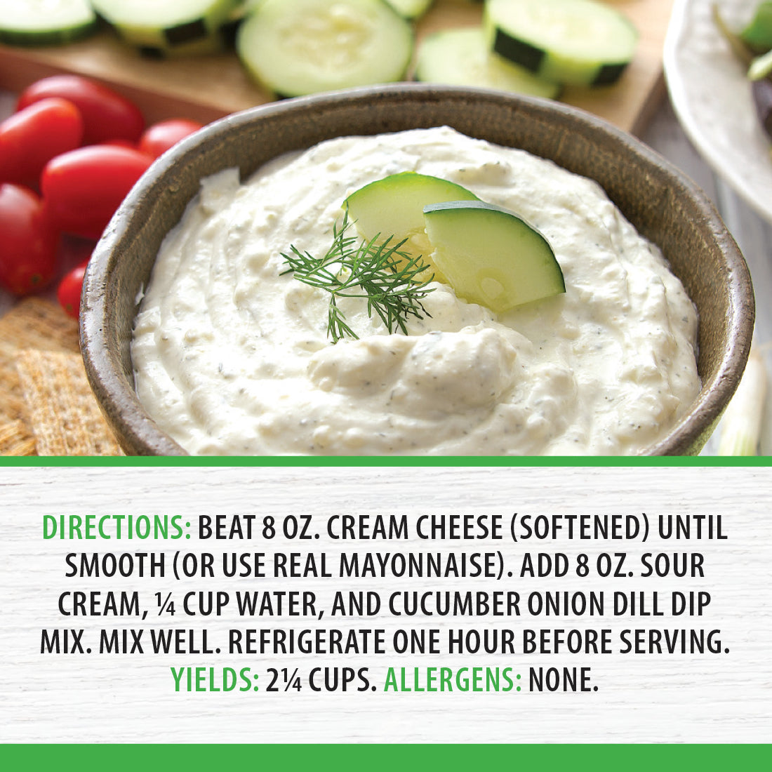 A bowl of Cucumber Onion Dill Dip next to crackers, cucumbers, and cherry tomatoes.