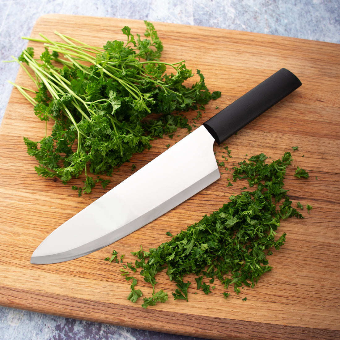 A French Chef knife next to cut asparagus