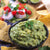 A bowl of Guacamole Dip with tortilla chips