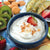 A bowl of Island Coconut Sweet Dip surrounded by fresh fruits