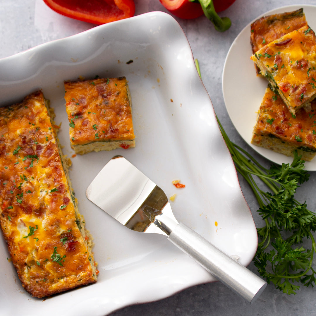 Rada Cutlery Mini Server with an egg bake in a white pan and a plate full of sliced egg bake.