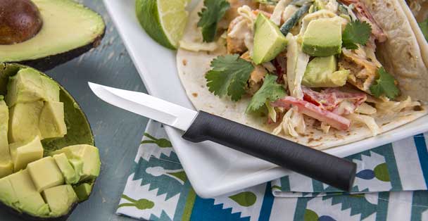 A black-handled Peeling Paring with chicken tacos.