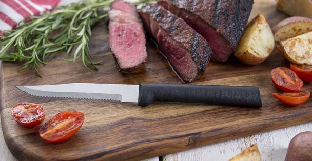 https://products.radacutlery.com/cdn/shop/products/serrated-steak-knife-sliced-steak_1200x.jpg?v=1687973513